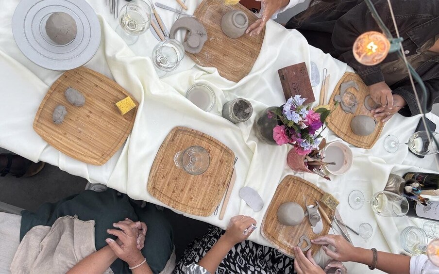 A table set with plates, bowls, cutlery, and candles, indicating a dining event. 3