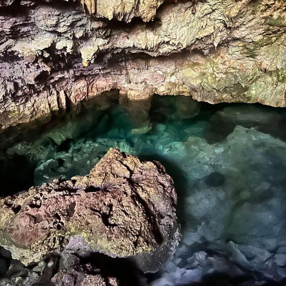 A cave with clear water and rocky formations. 3