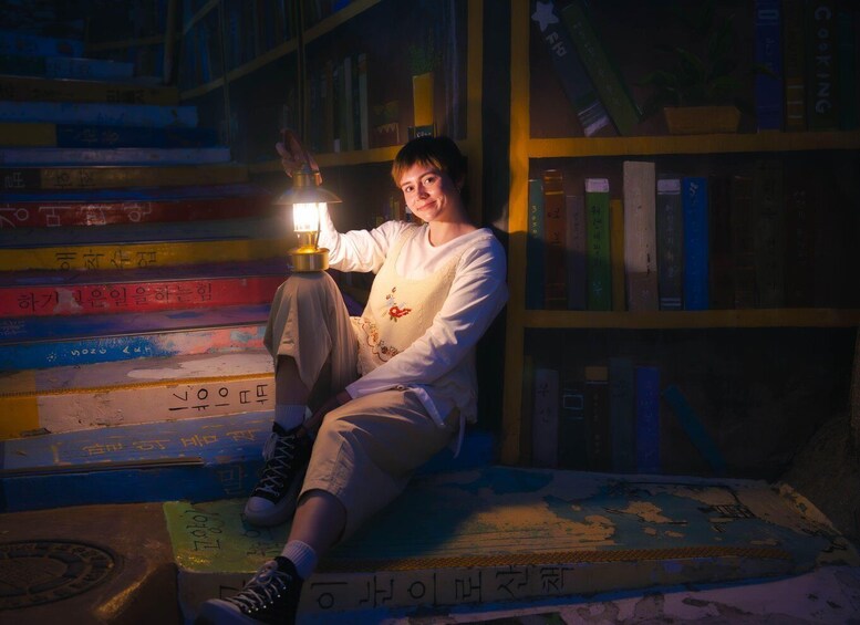 A person sitting on a map, surrounded by bookshelves filled with books. 3