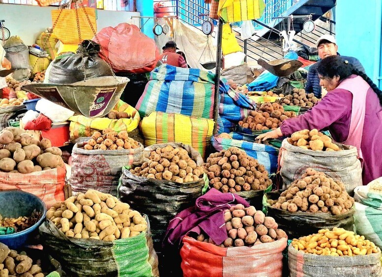 A market with sacks of potatoes and other produce. 3