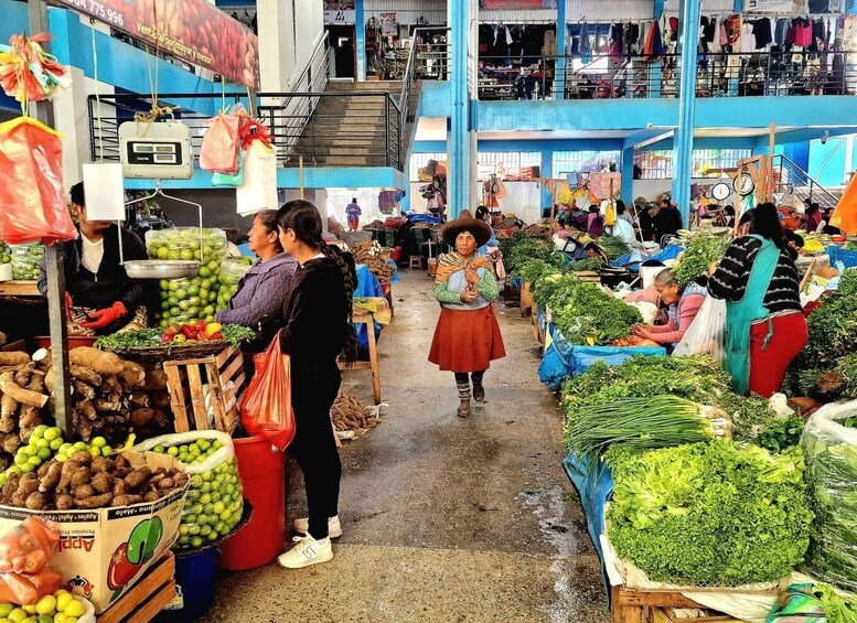 A bustling indoor market with various stalls selling fresh produce and goods. 4