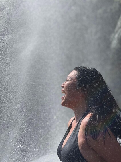 A person in a black top with water droplets visible, suggesting a water activity. 2