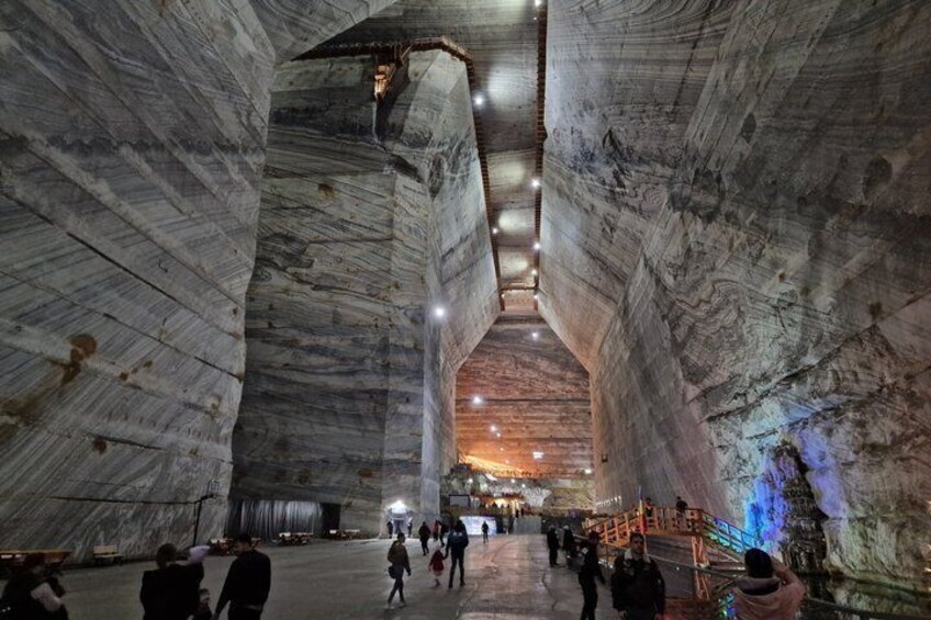 A large, cavernous interior with high ceilings and natural rock formations. 3