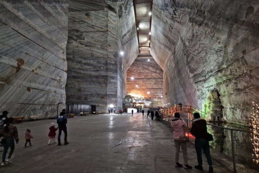 A large cavernous space with high ceilings and natural rock formations. 4