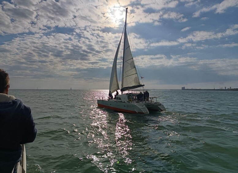 A sailboat on calm waters with a partly cloudy sky. 5