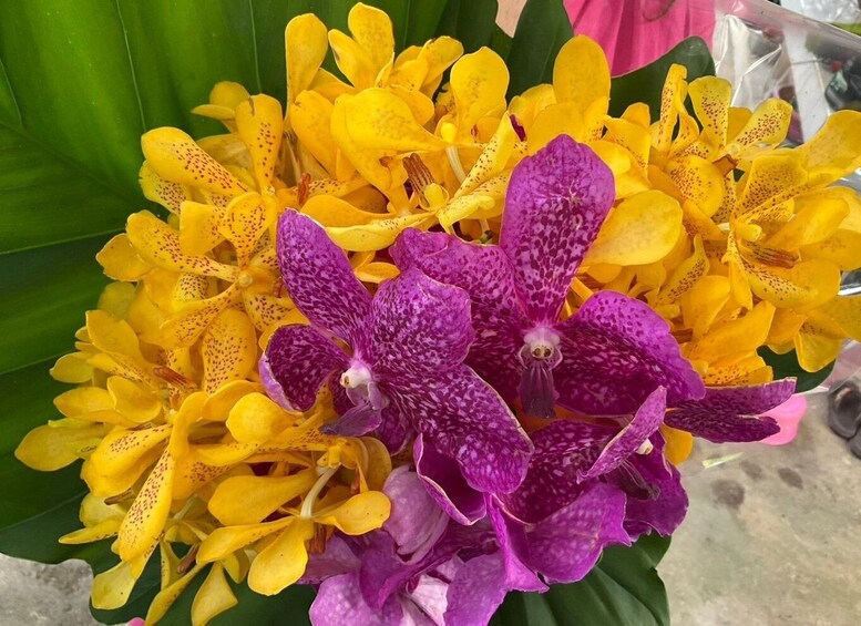 A bouquet of yellow and purple orchids. 4