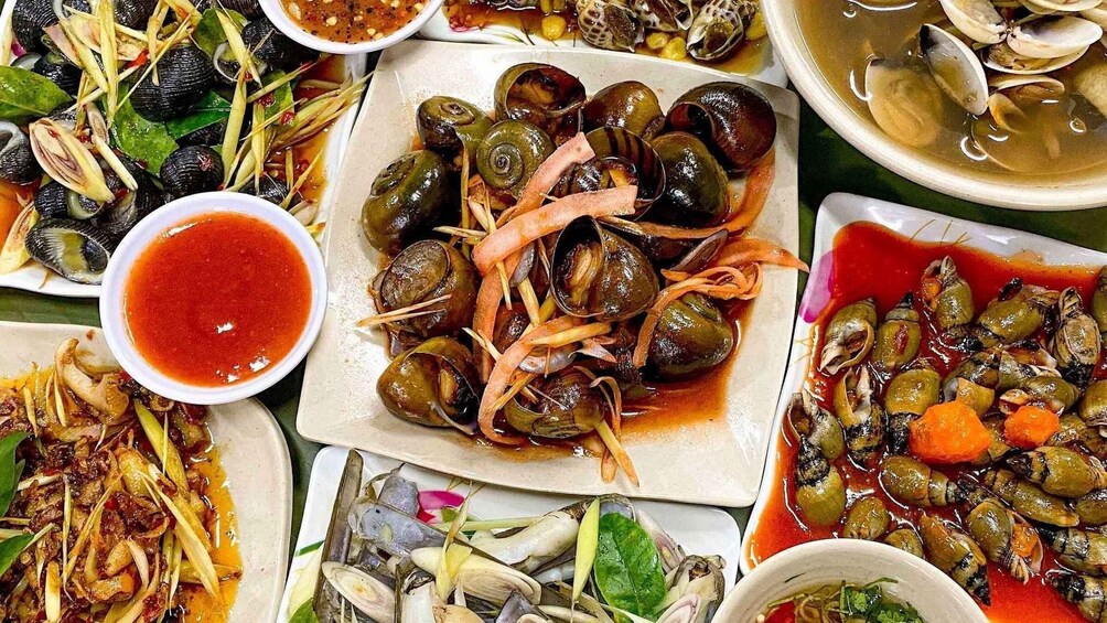 A variety of seafood dishes, including mussels and clams, served with different sauces and garnishes. 4