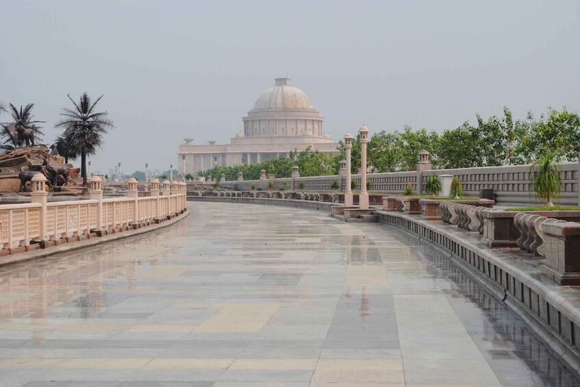 A grand, domed building with a reflective marble floor and ornate railings. 3