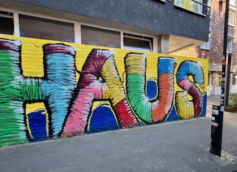 A colorful graffiti mural on a building wall. 2