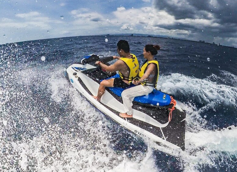 Two people on a jet ski in the ocean. 4