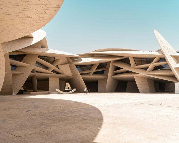 A modern architectural structure with a unique, curved design. 1