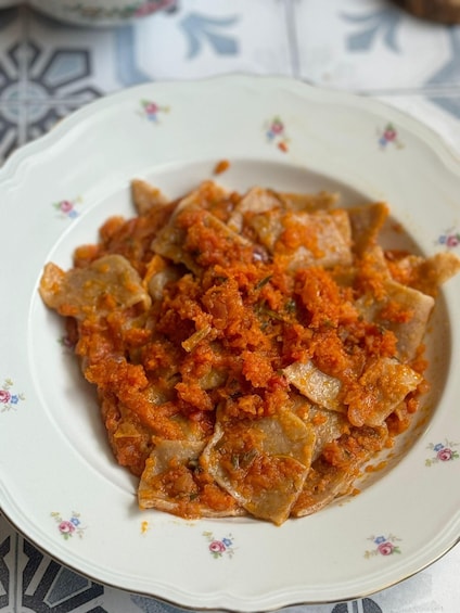 A plate of stuffed pasta with a tomato-based sauce. 3