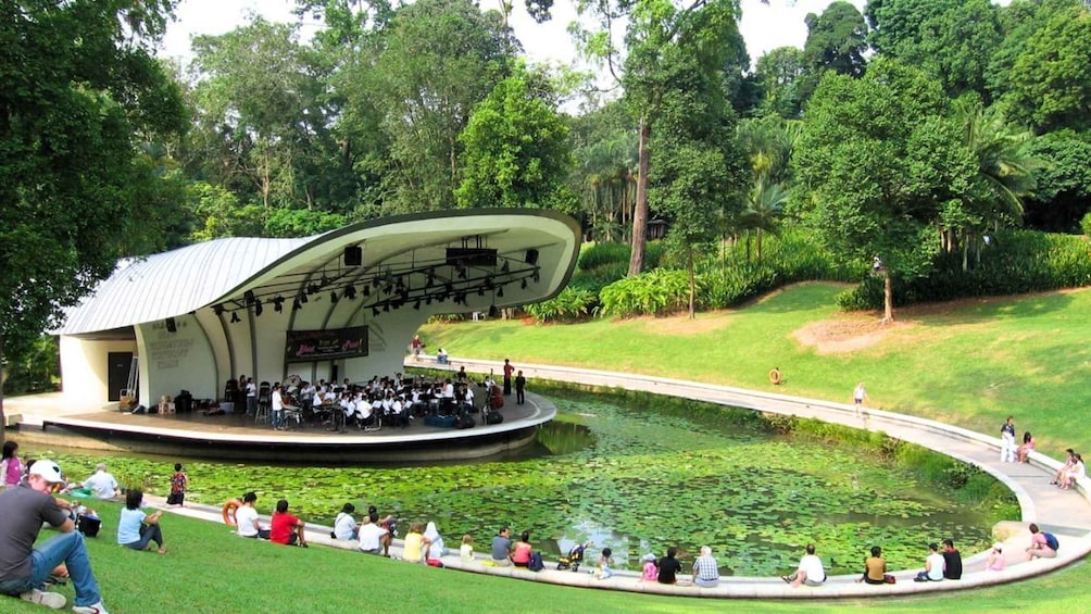 A park with a unique pavilion and a pond with lily pads. 4