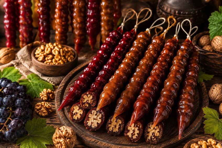 Dried chili peppers, walnuts, and grapes on a wooden board. 2