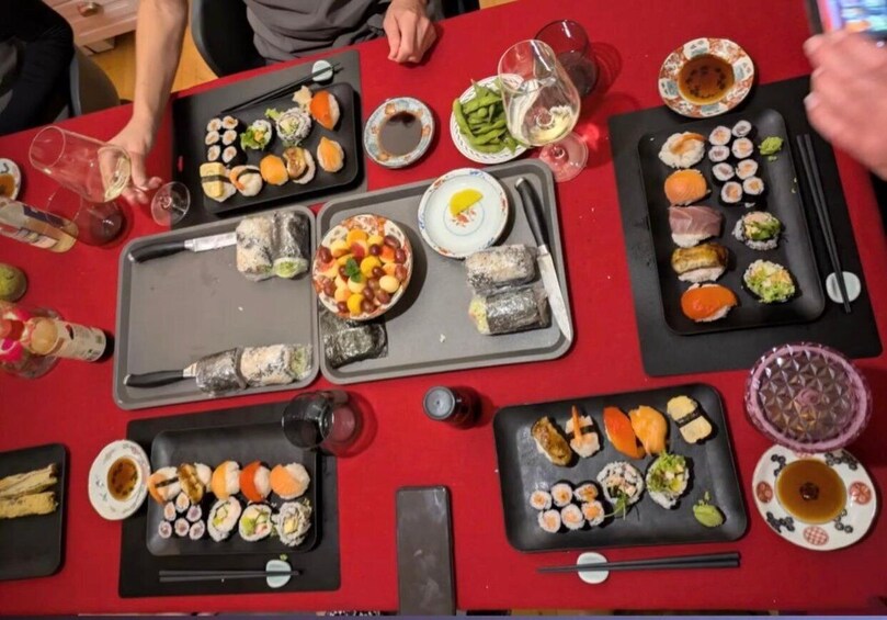 A table with various sushi dishes and drinks. 1