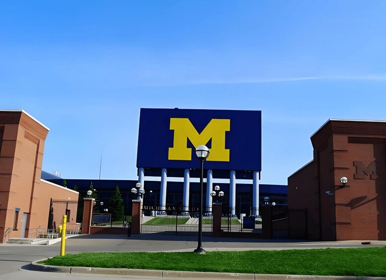 A building with a large 'M' sign, likely a university entrance. 1