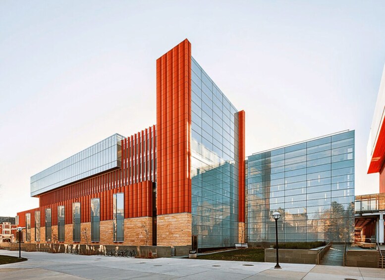 A modern building with red vertical elements and large glass windows. 3