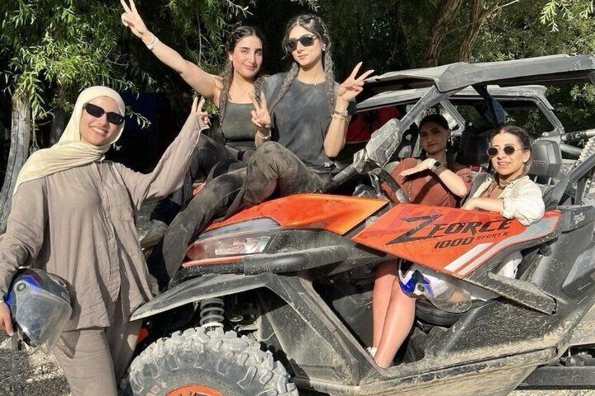 A group of people posing with a 4x4 vehicle. 5