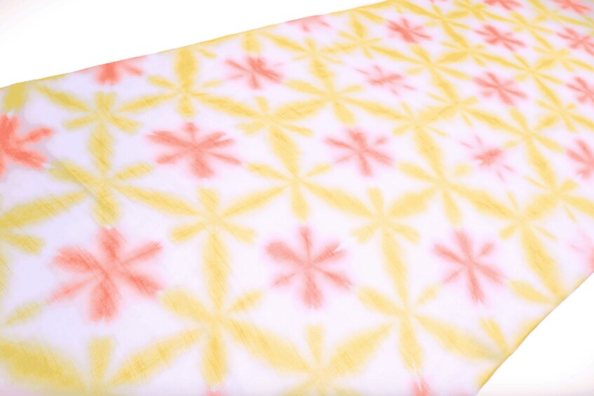 A pattern of yellow and pink shapes on a white background. 4