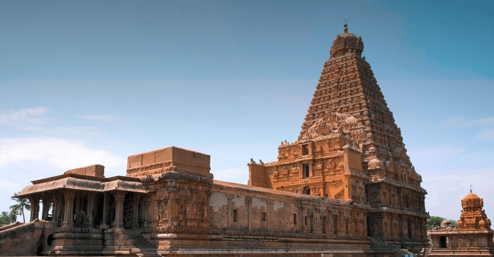 A large temple with a tall, ornate tower and a smaller dome structure. 1