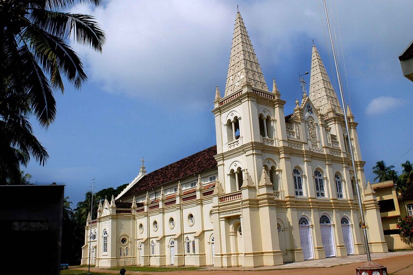 A colonial-style church with two prominent towers and a red-tiled roof. 2