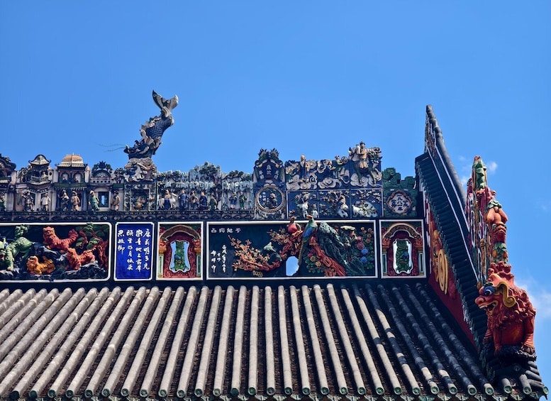 A traditional Chinese roof with ornate carvings and dragons. 5