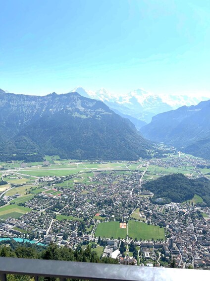 A mountainous landscape with a town nestled in the valley. 1