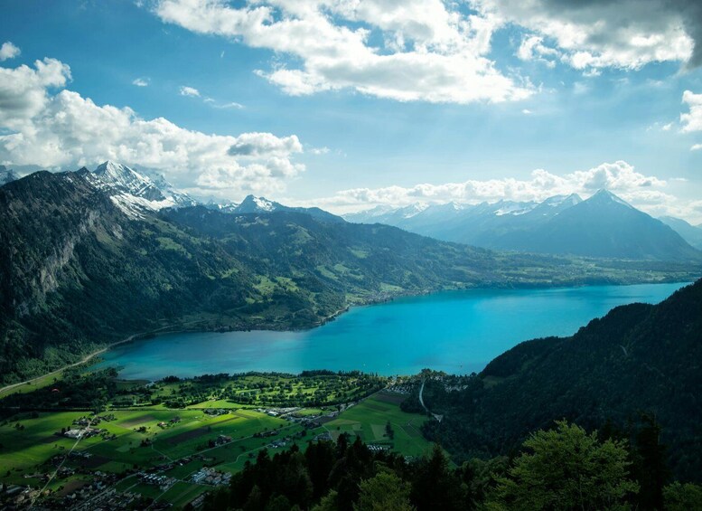 A mountainous landscape with a lake and a village. 3