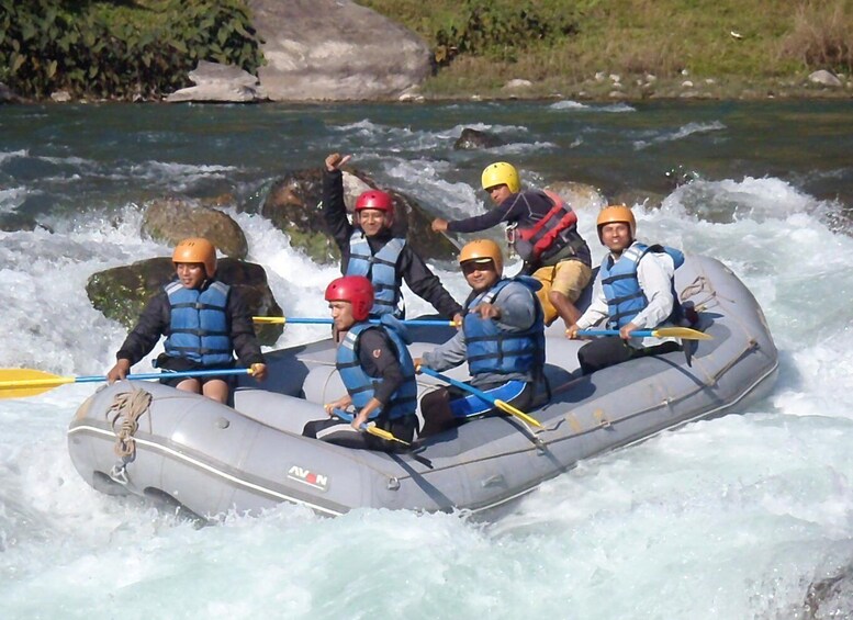 A group of people rafting down a river in a raft. 5