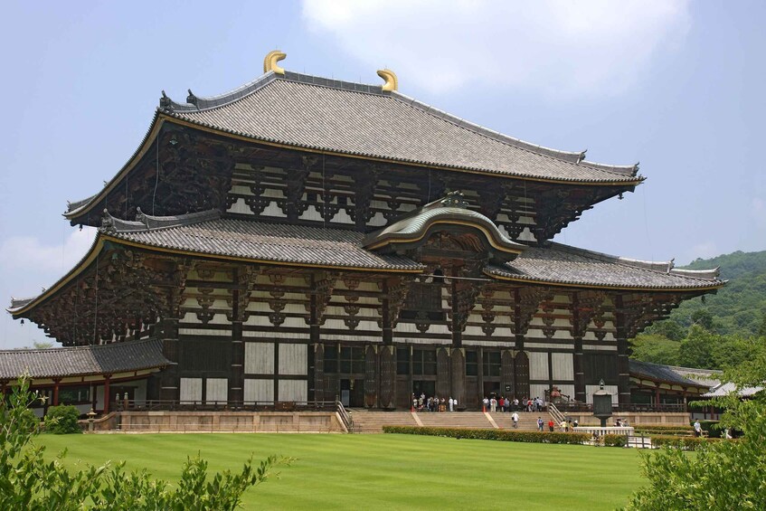 A traditional Japanese building with a multi-tiered roof and ornate wooden architecture. 3