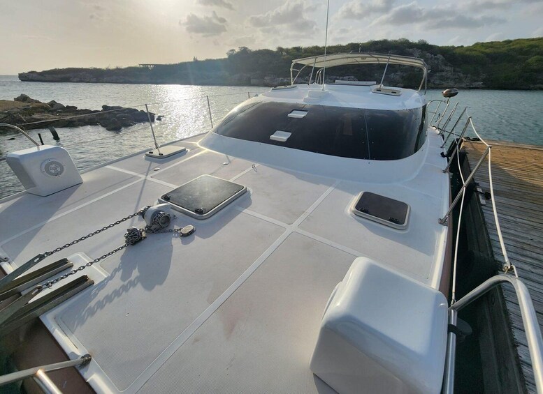 A boat deck with a covered seating area, a speaker, and a smartphone charging port. 5