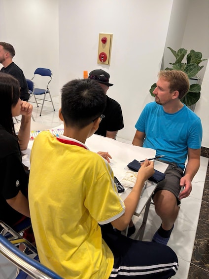 A group of people seated around a table, engaged in a discussion or meeting. 5