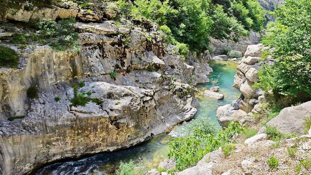 A rocky gorge with a clear stream flowing through it. 5