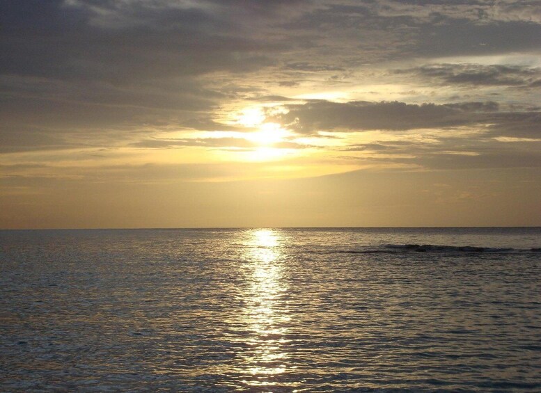 A sunset over a calm sea with a clear horizon. 4
