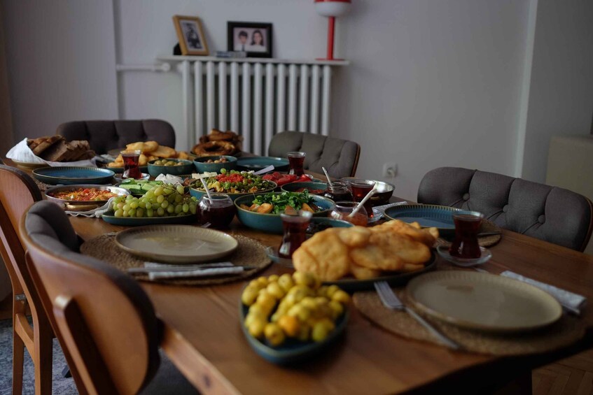 A dining table with various dishes, including salads, bread, and drinks. 2