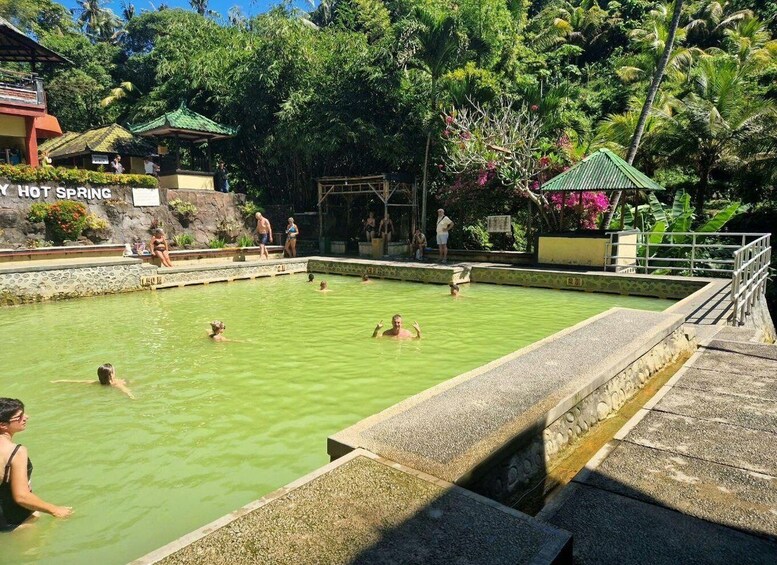 A hot spring with people swimming and relaxing. 3