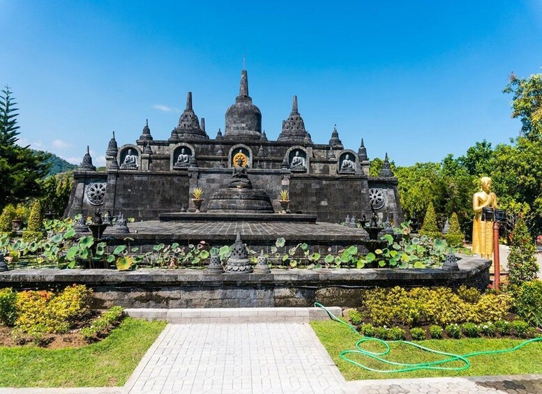 A temple with multiple spires and statues, surrounded by lotus ponds and greenery. 1