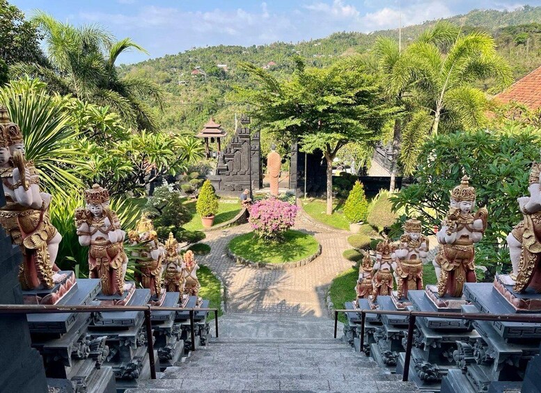 A temple complex with ornate statues, a central shrine, and a surrounding garden. 4