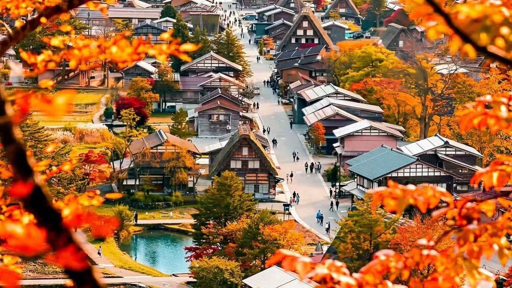 A traditional Japanese village with wooden houses and a central pathway. 1