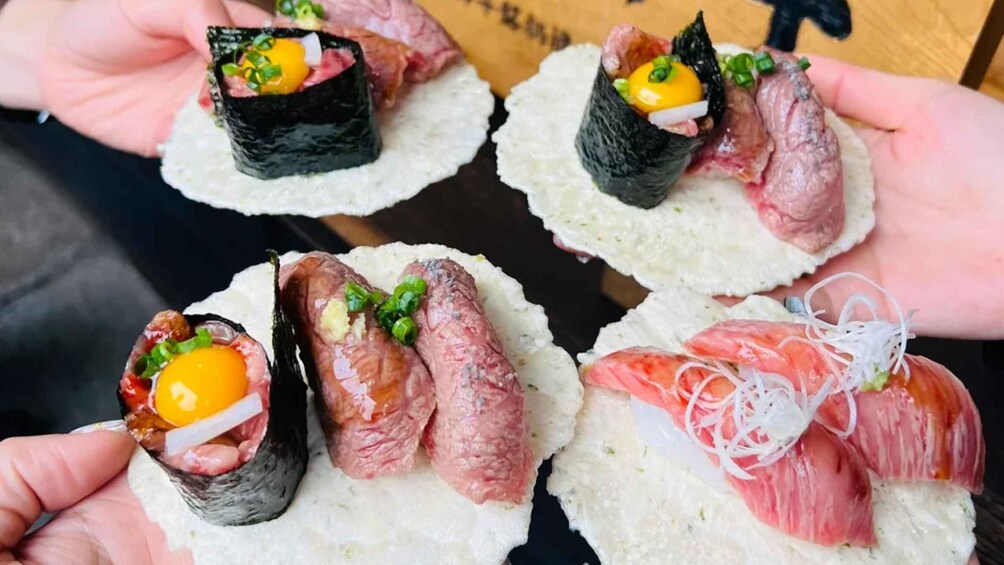 A variety of sushi dishes, including nigiri with fish, egg, and vegetables, served on small white plates. 2