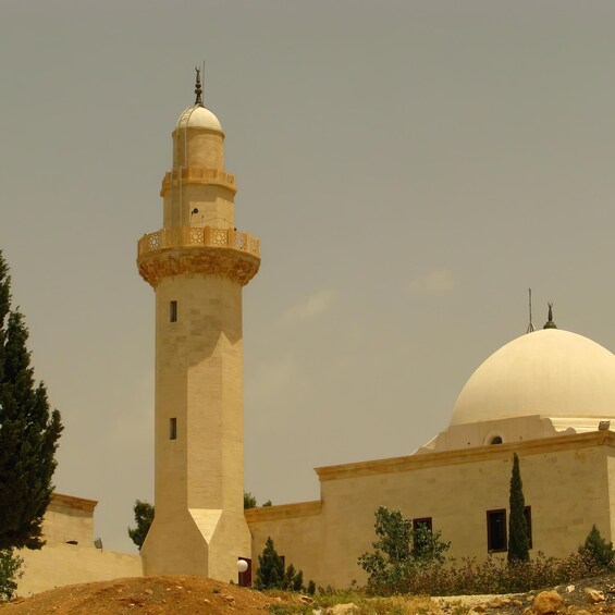 A mosque with a tall minaret and a large dome. 4