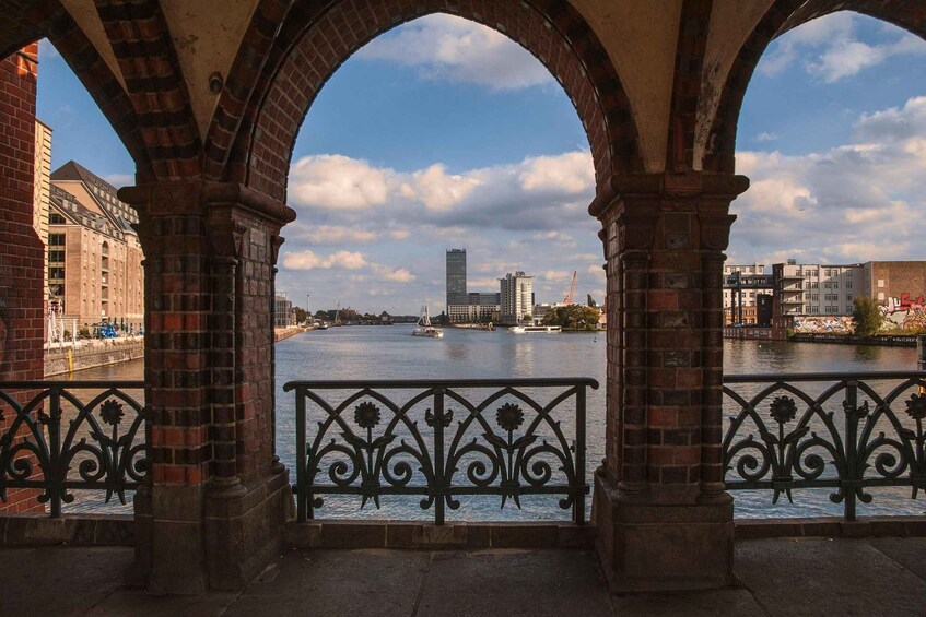 A river with a bridge, buildings, and a clear sky. 5