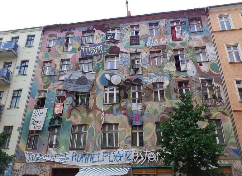 A building with colorful graffiti and various signs, including one that says 'TERROR.' 3