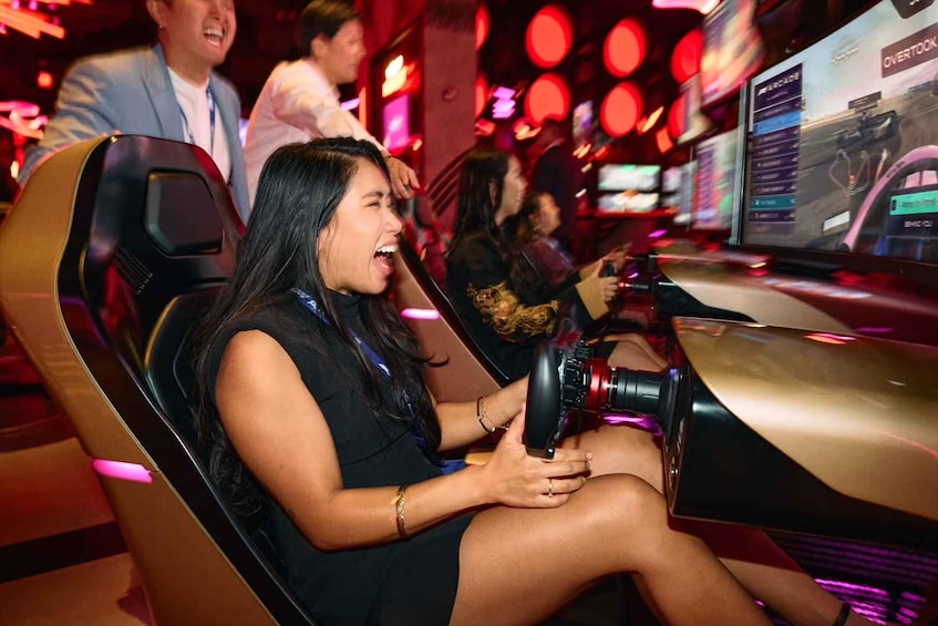 A person seated in a gaming chair, holding a camera. 3