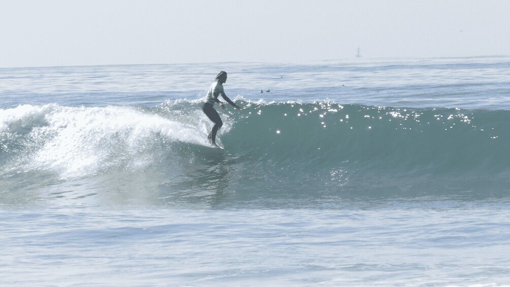 A surfer riding a wave in the ocean. 1
