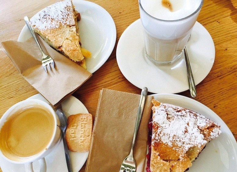 A table with a slice of pie, a cup of coffee, a glass of milk, and a biscuit. 5