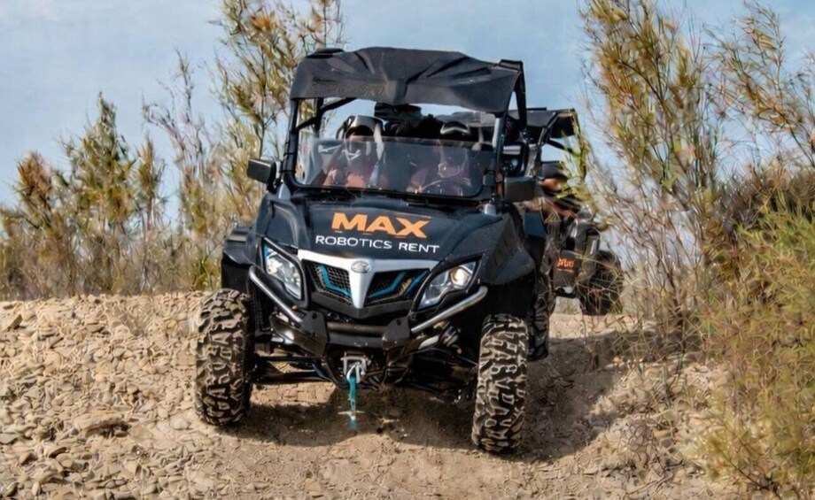A black off-road vehicle with 'MAX ROBOTICS RENT' on the front. 1