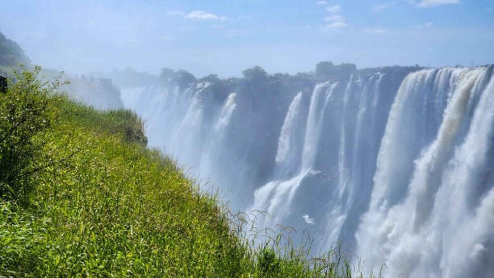 A waterfall cascading down a grassy slope. 4