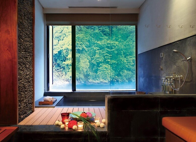 A modern bathroom with a large window, a wooden floor, and a stone wall. 4