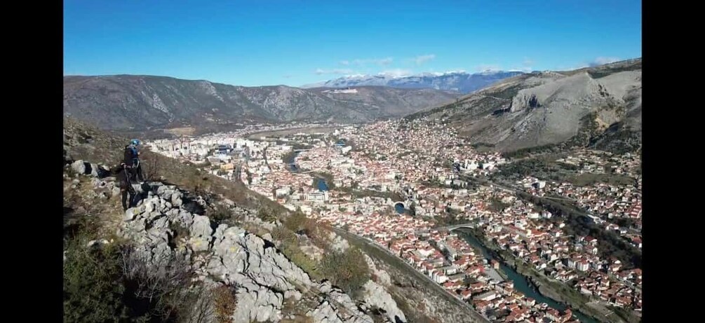 A mountainous landscape with a town nestled in the valley below. 4